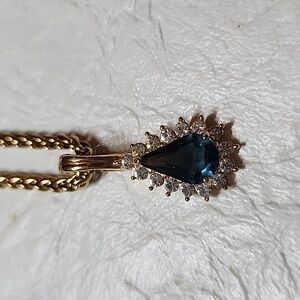 Blue Topaz simulant center gem with diamond simulant accent gems pendant